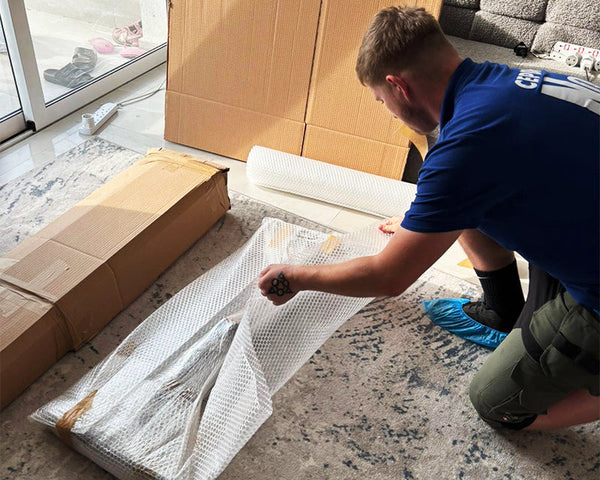 Avector employee wrapping a delivery